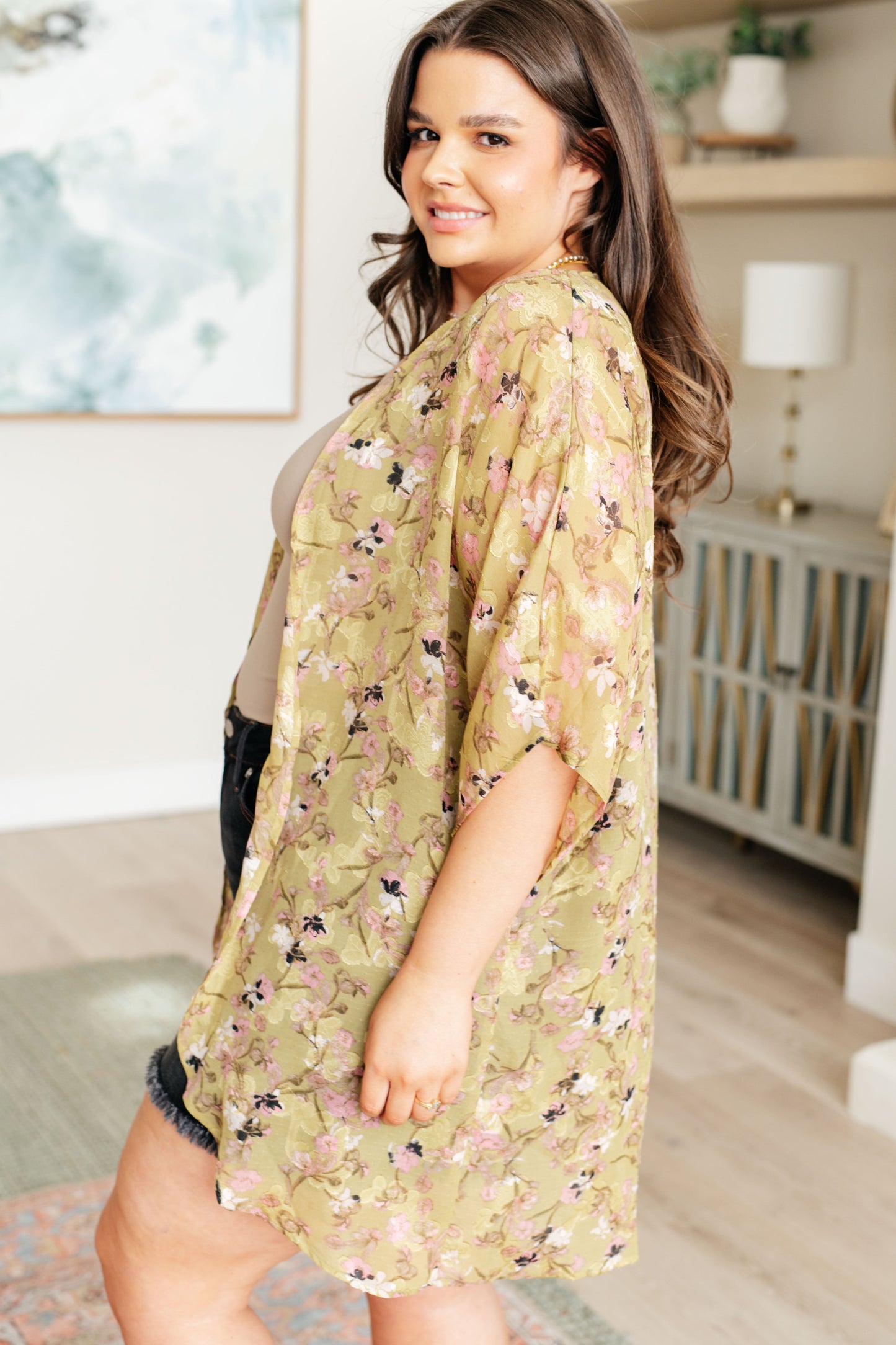 Woman wearing a floral kimono in a home setting