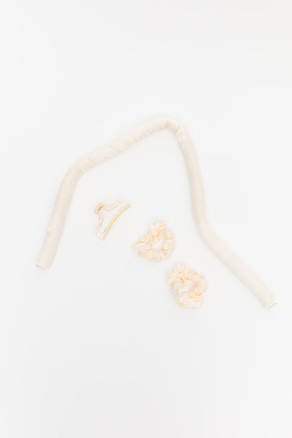 Close-up of a beige headband with floral designs on a light background