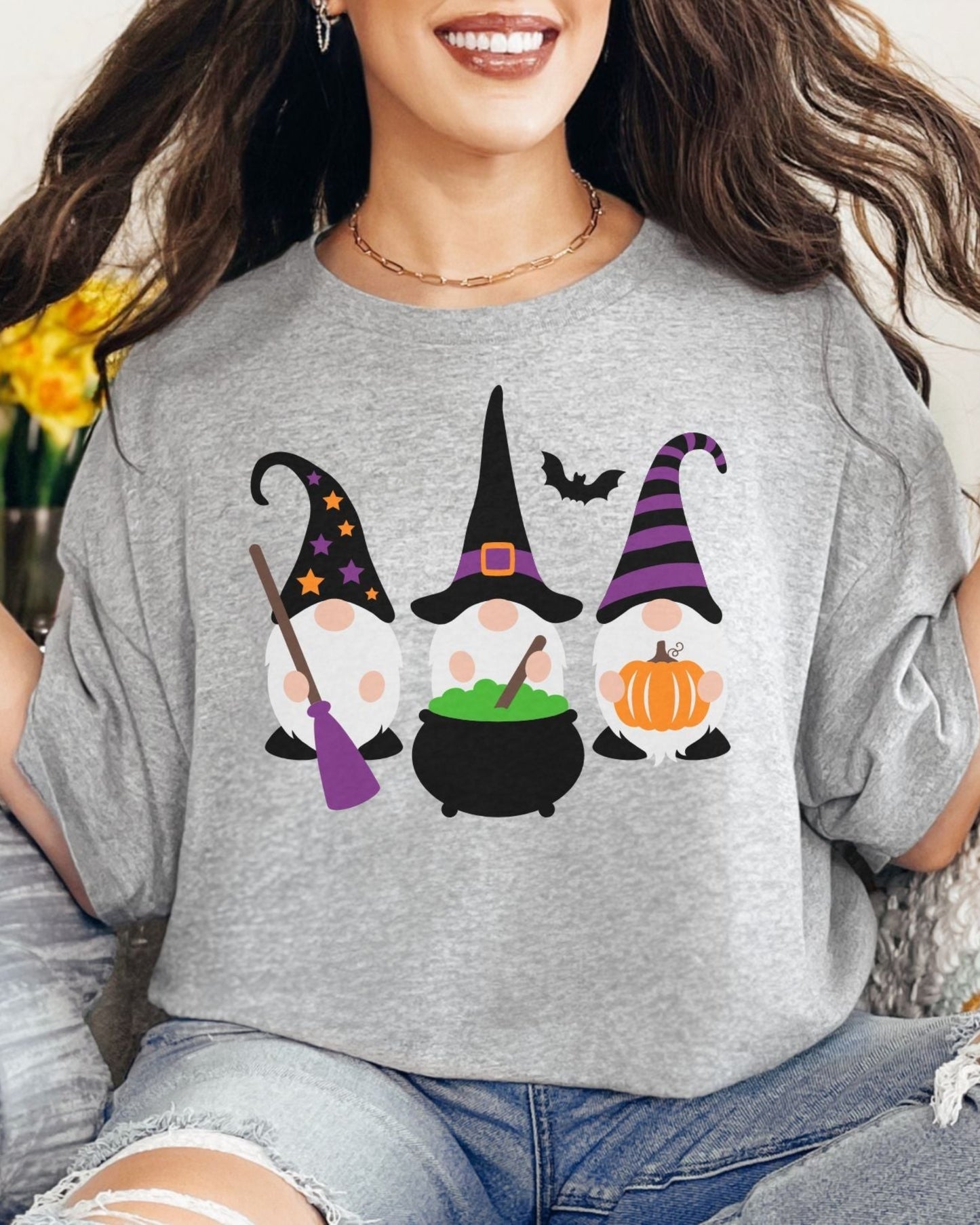 Woman wearing a gray t-shirt with Halloween-themed gnomes design.