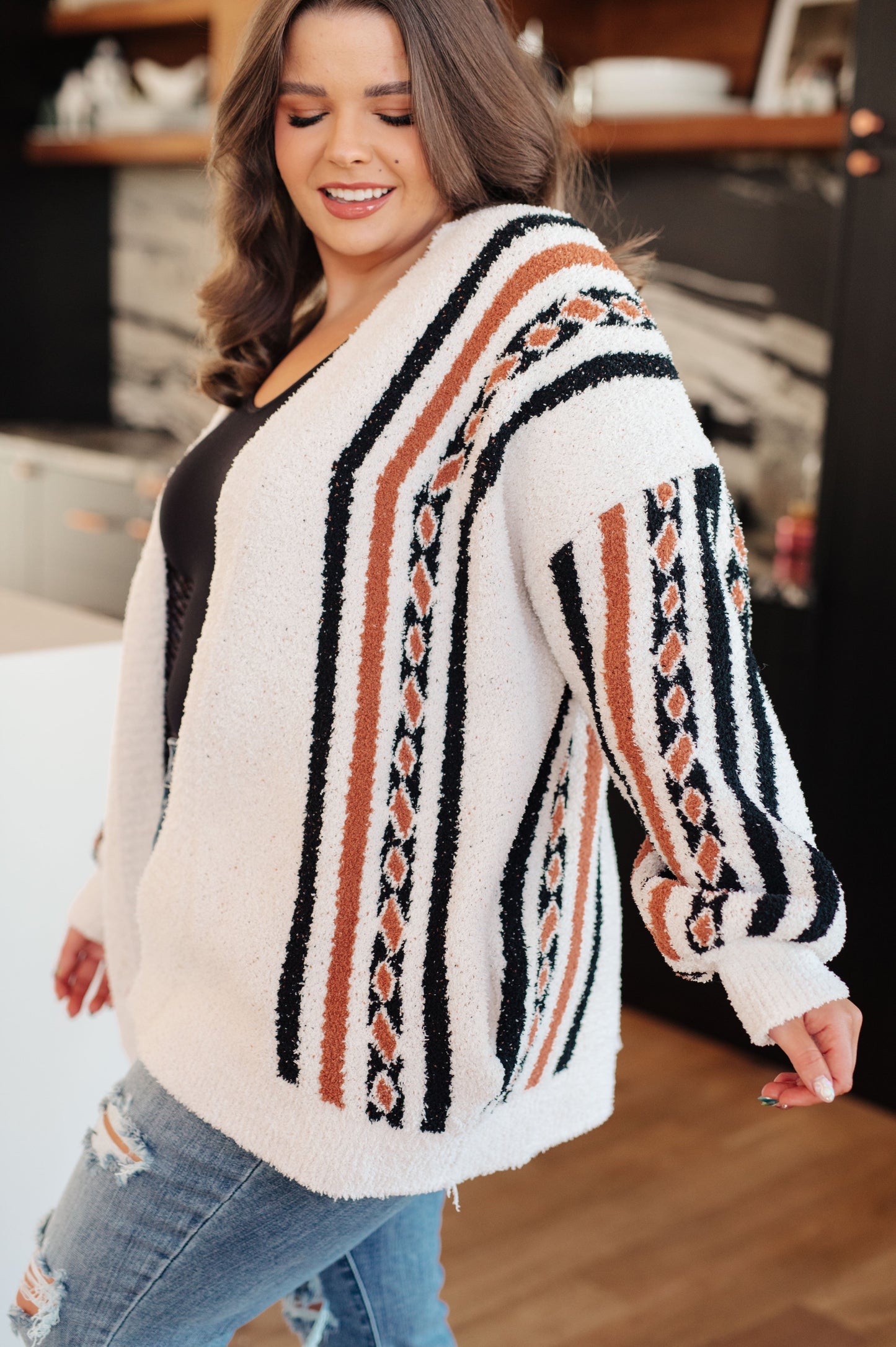 Woman wearing a patterned sweater in an indoor setting