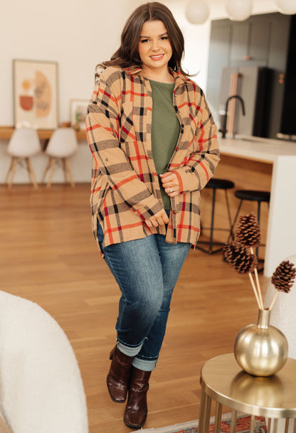 Woman wearing a plaid coat in a home setting