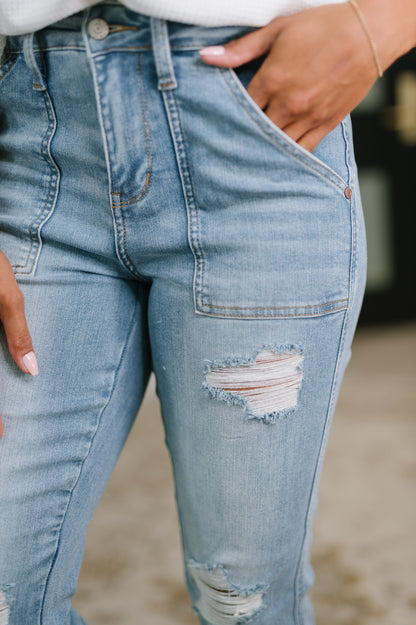 Close-up of light blue jeans with a tear on a blurred background