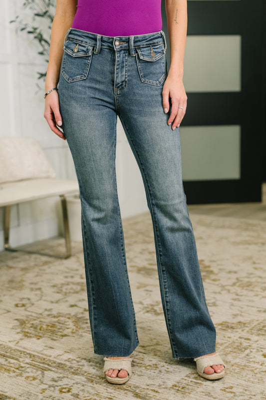 Person wearing blue jeans and a purple top in an indoor setting