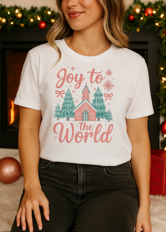 Person wearing a white t-shirt with a Christmas design and text, standing in front of a decorated fireplace.