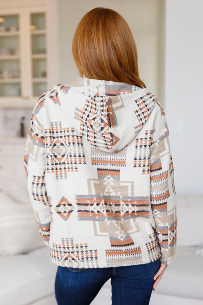 Person wearing a patterned jacket in an indoor setting