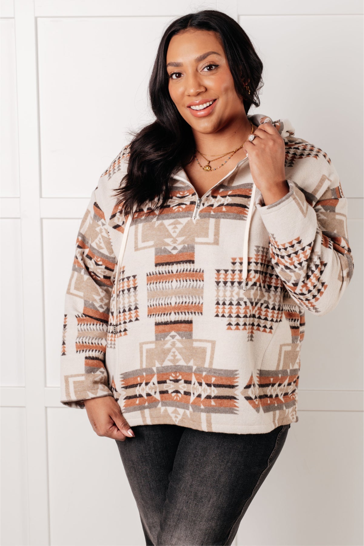 Woman wearing a patterned hoodie against a white background