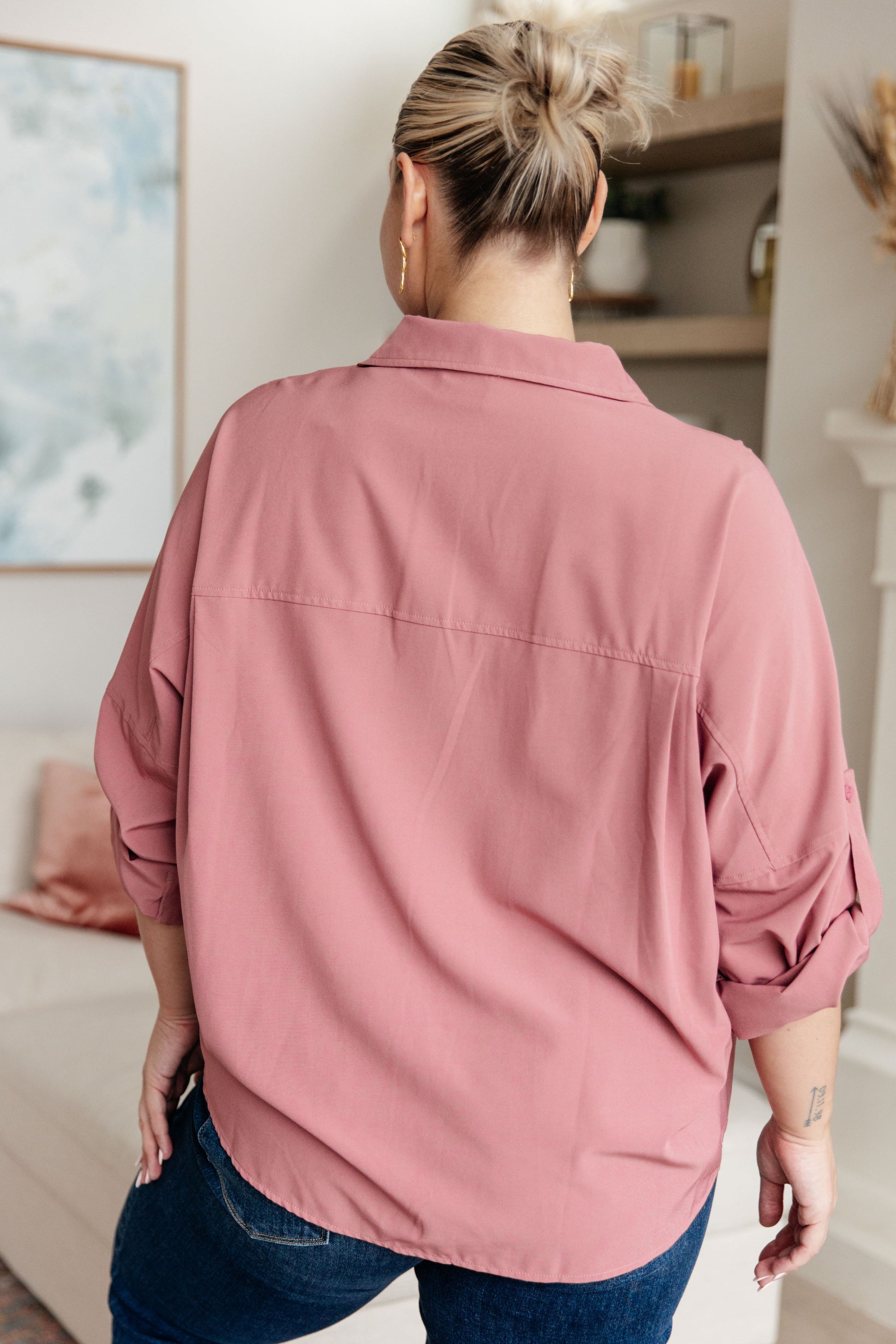 Person wearing a pink shirt in an indoor setting