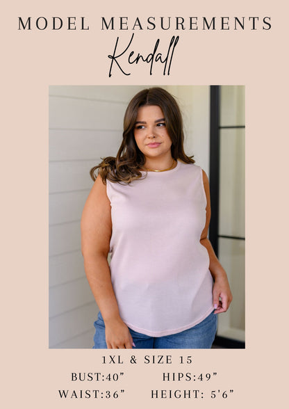 Woman wearing a light pink sleeveless top with model measurements displayed below.