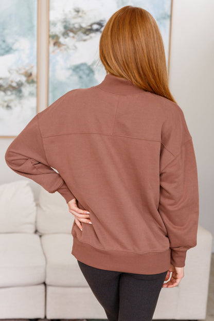 Person wearing a brown jacket in an indoor setting