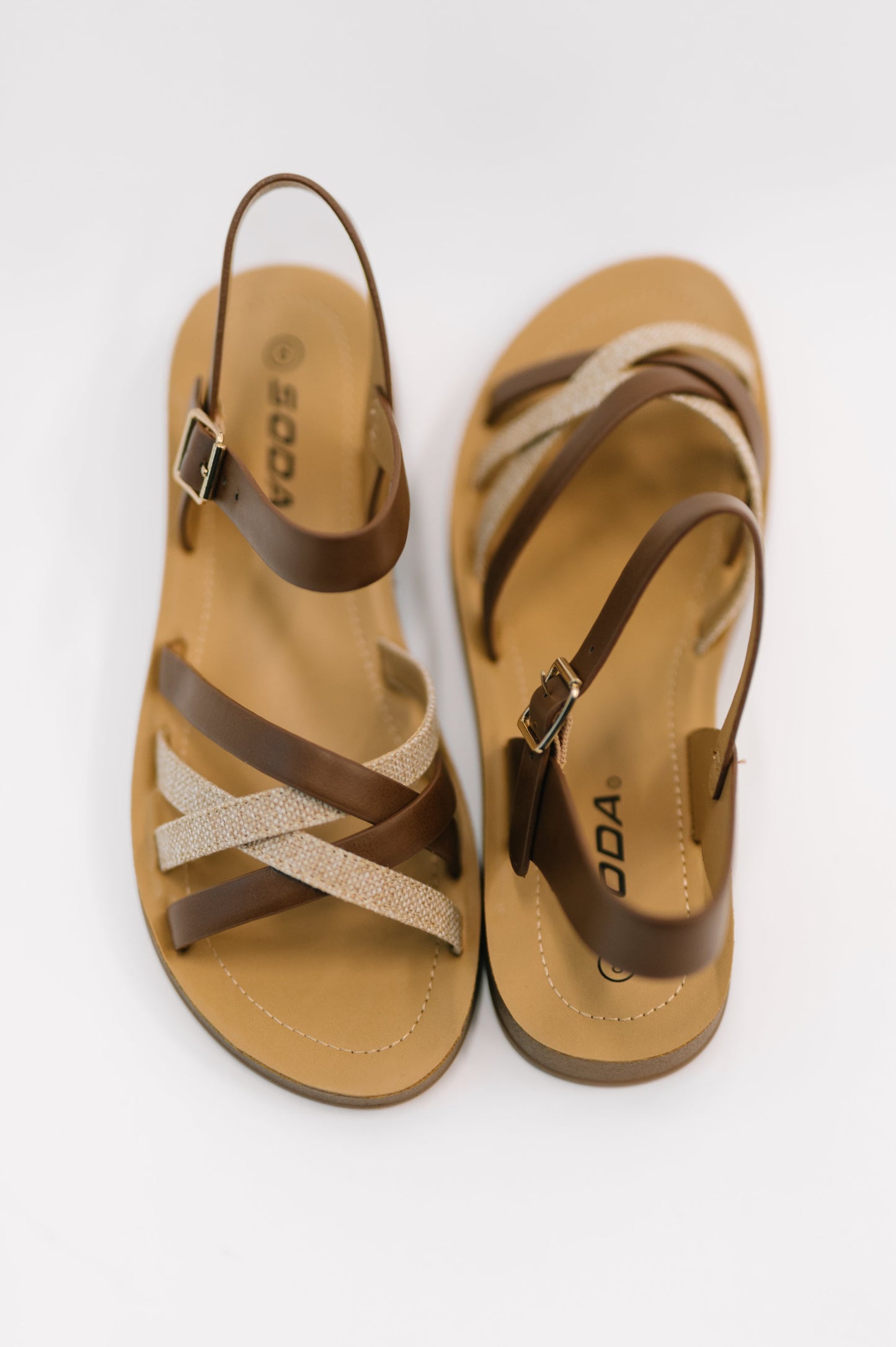 Pair of tan and brown sandals with 'DO&CO' branding on a white background