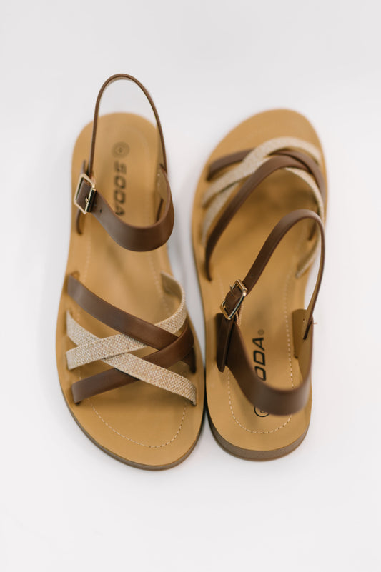 Pair of tan and brown sandals with 'DO&CO' branding on a white background
