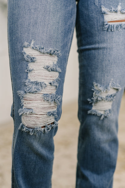 Close-up of distressed blue jeans on a blurred background