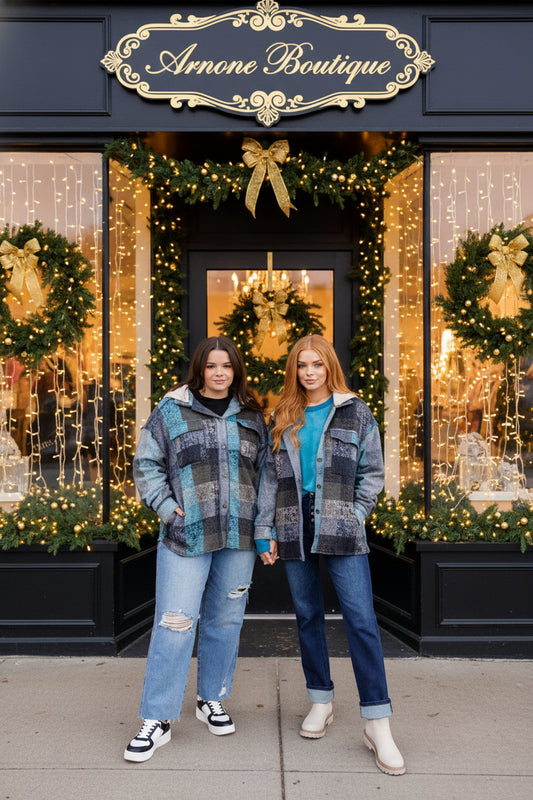 Two women standing in front of Arnone Boutique with festive decorations.