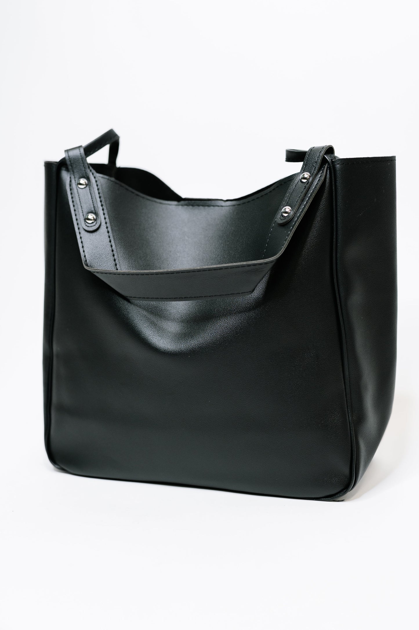 Black leather tote bag on a white background