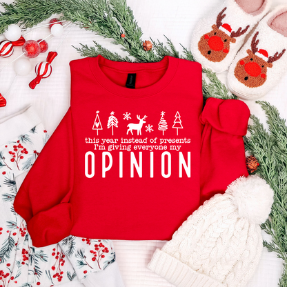 Red sweatshirt with humorous text on a festive background with Christmas decorations.
