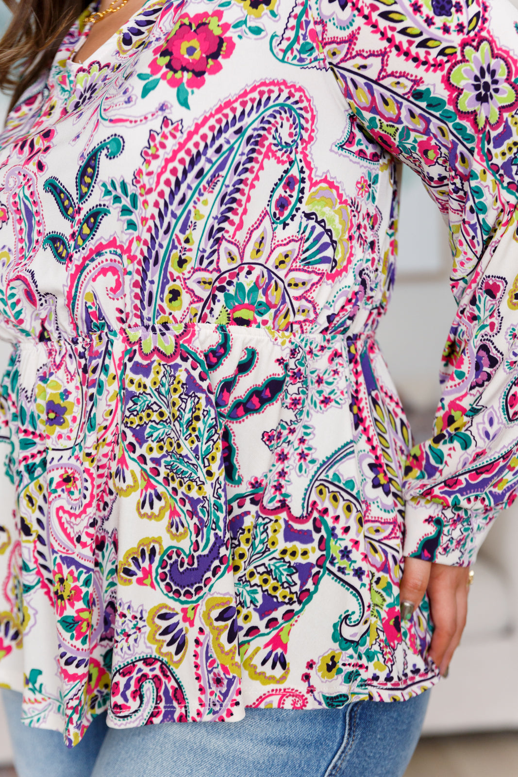 Colorful paisley patterned blouse with a blurred background