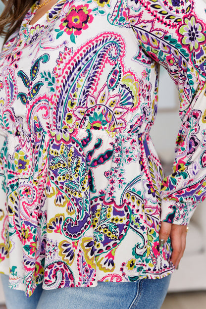 Colorful paisley patterned blouse with a blurred background