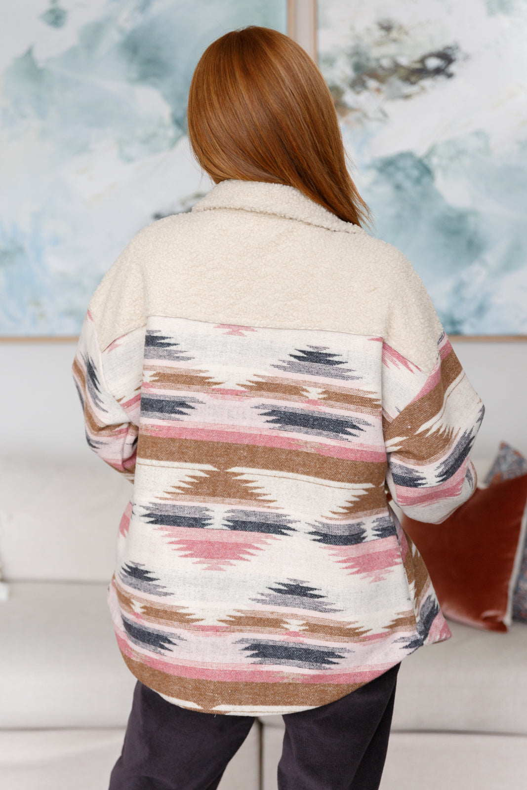 Person wearing a patterned jacket with a blurred background