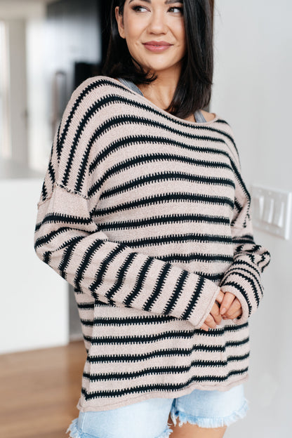 Woman wearing a black and white striped sweater in a casual setting