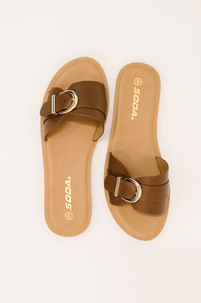 Brown sandals with a gold buckle on a white background