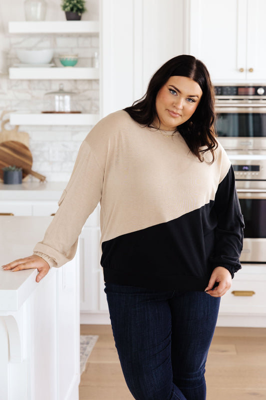 Woman wearing a two-tone shirt in a kitchen setting