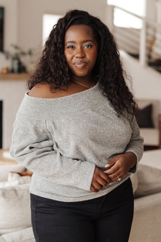 Woman wearing a gray sweater in a home setting