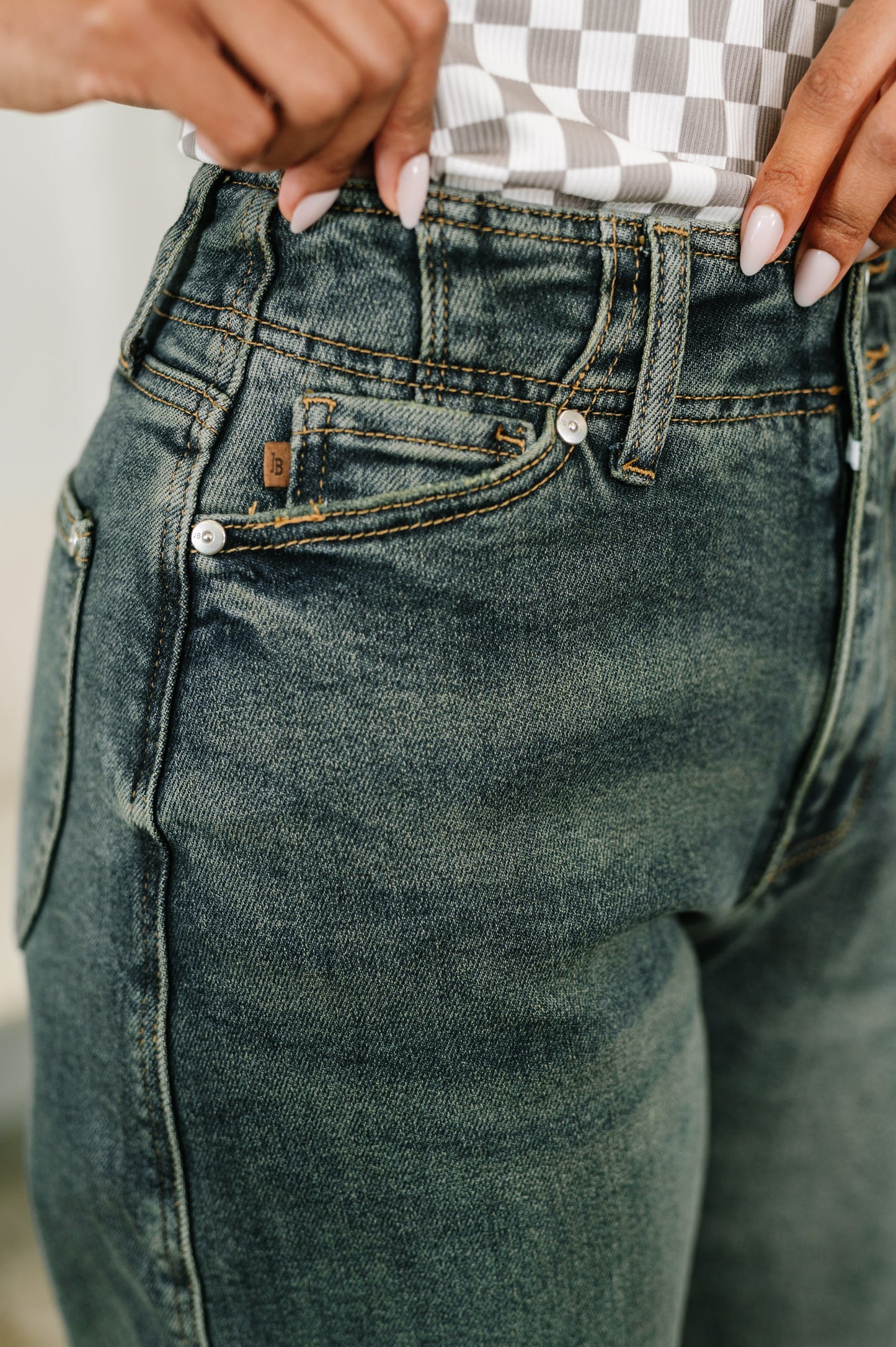 Close-up of a person wearing blue jeans with a blurred background
