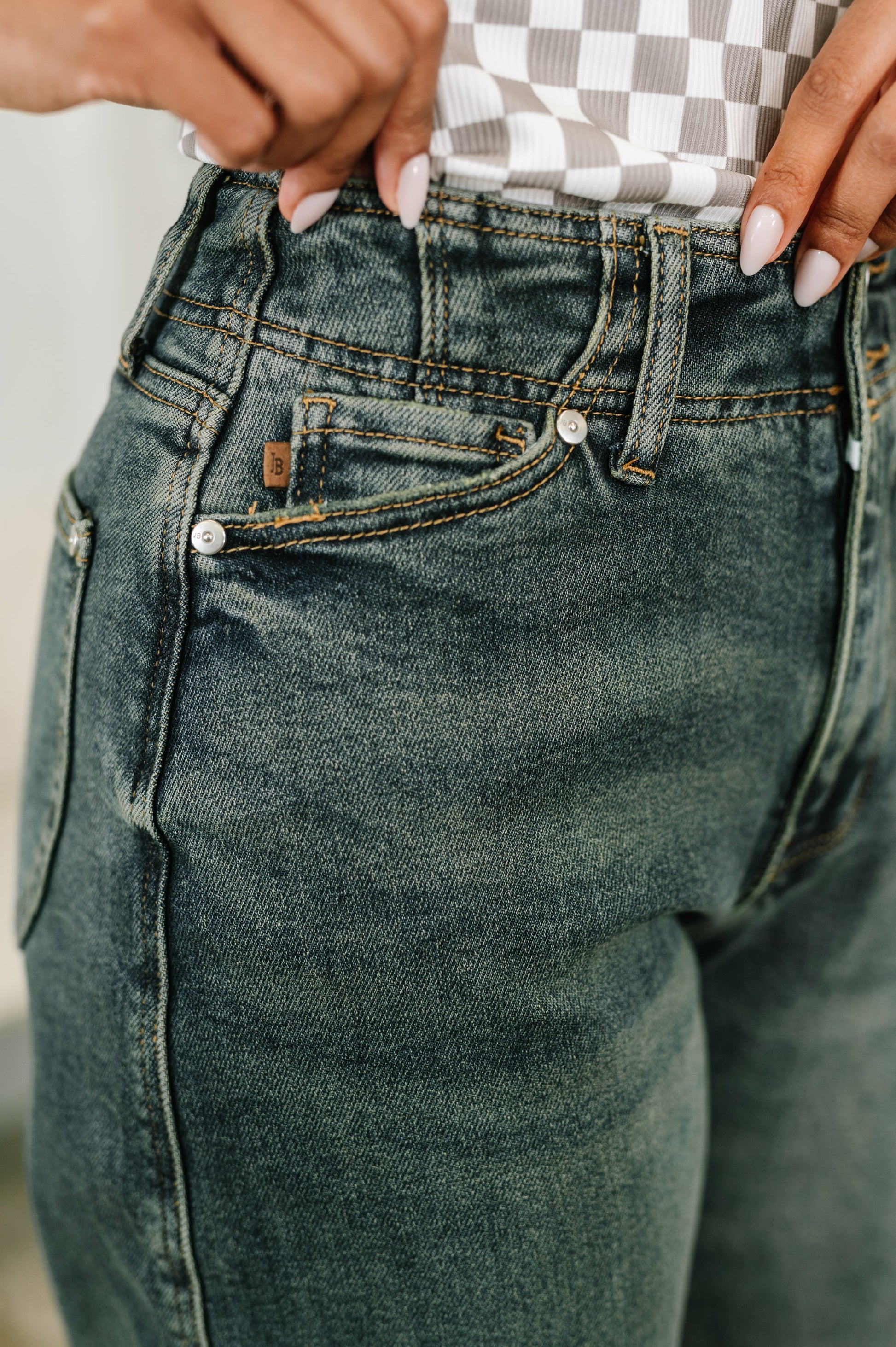 Close-up of a person wearing blue jeans with a blurred background