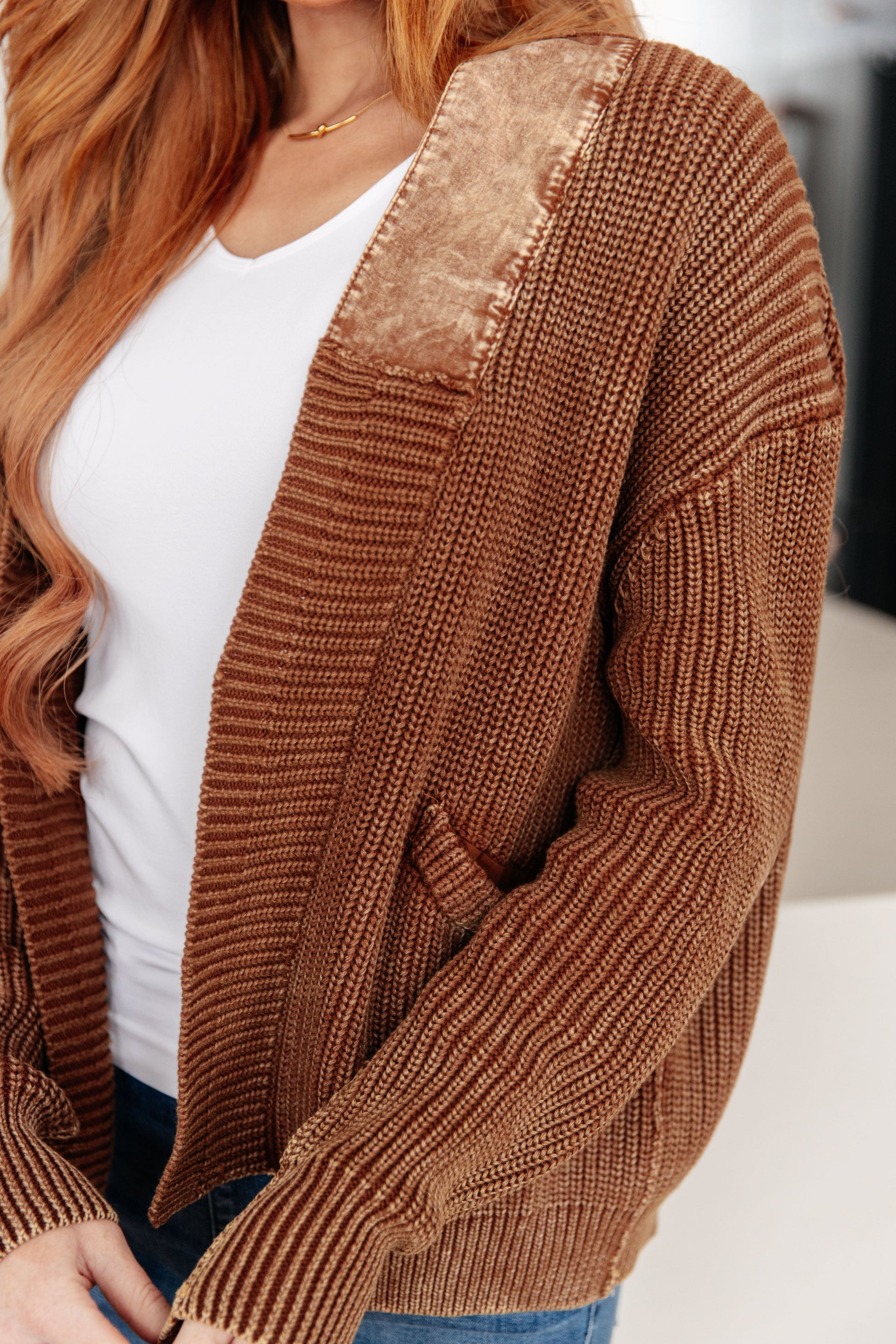 Brown ribbed knit cardigan with sequin detail worn by a person.