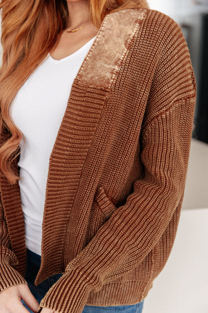 Brown ribbed knit cardigan with sequin detail worn by a person.