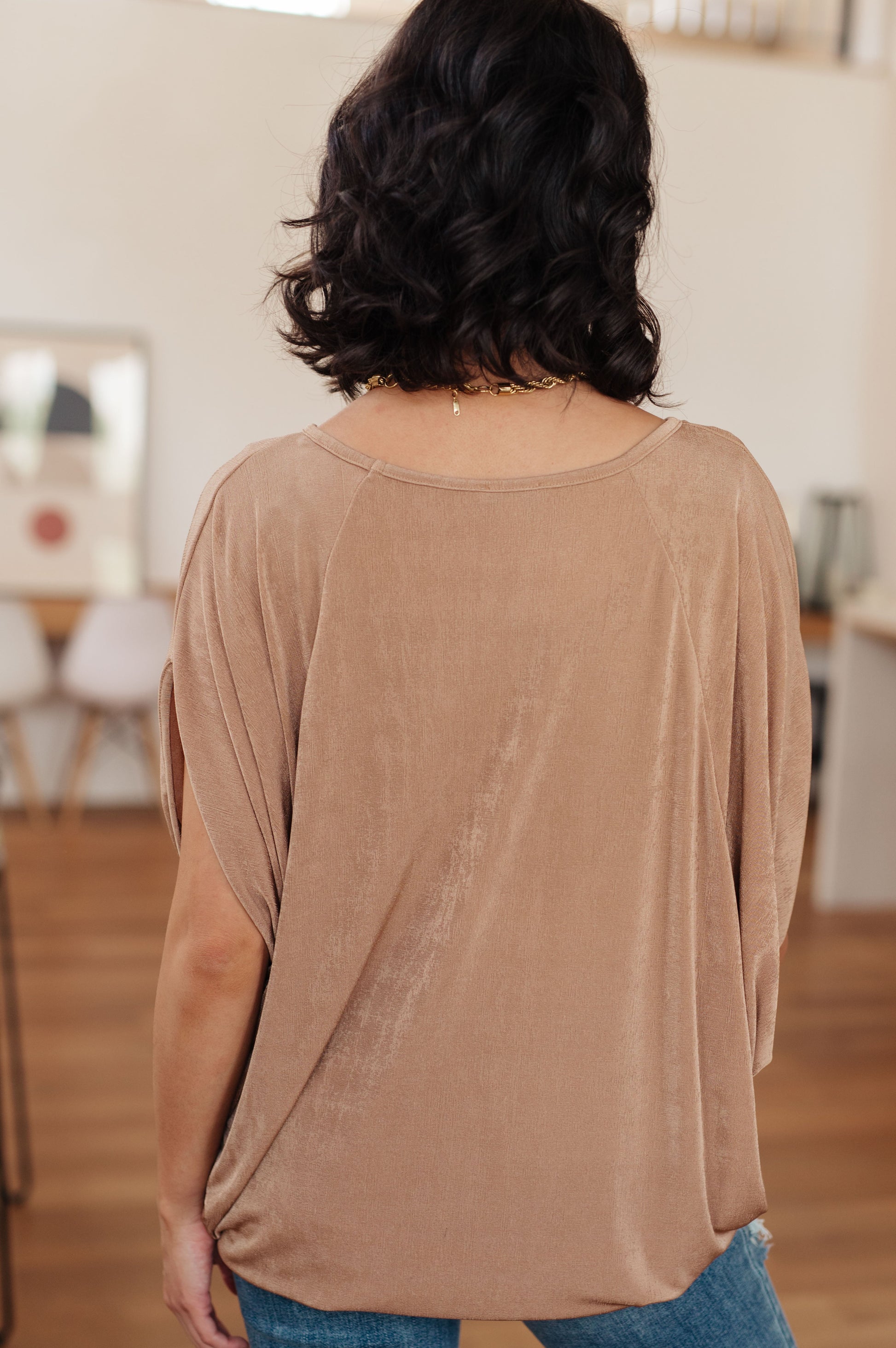 Person wearing a brown top in an indoor setting