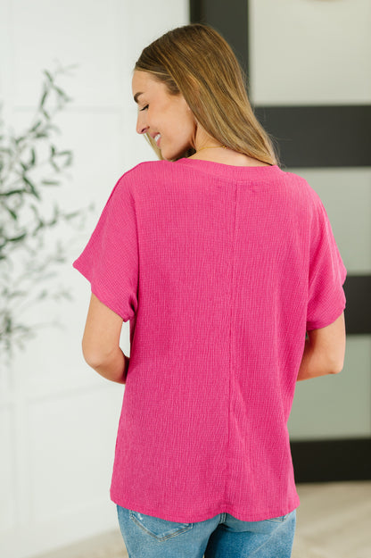 Person wearing a pink shirt in a casual setting