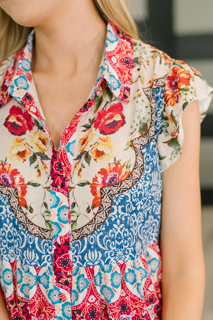 Close-up of a colorful floral and patterned shirt worn by a person.