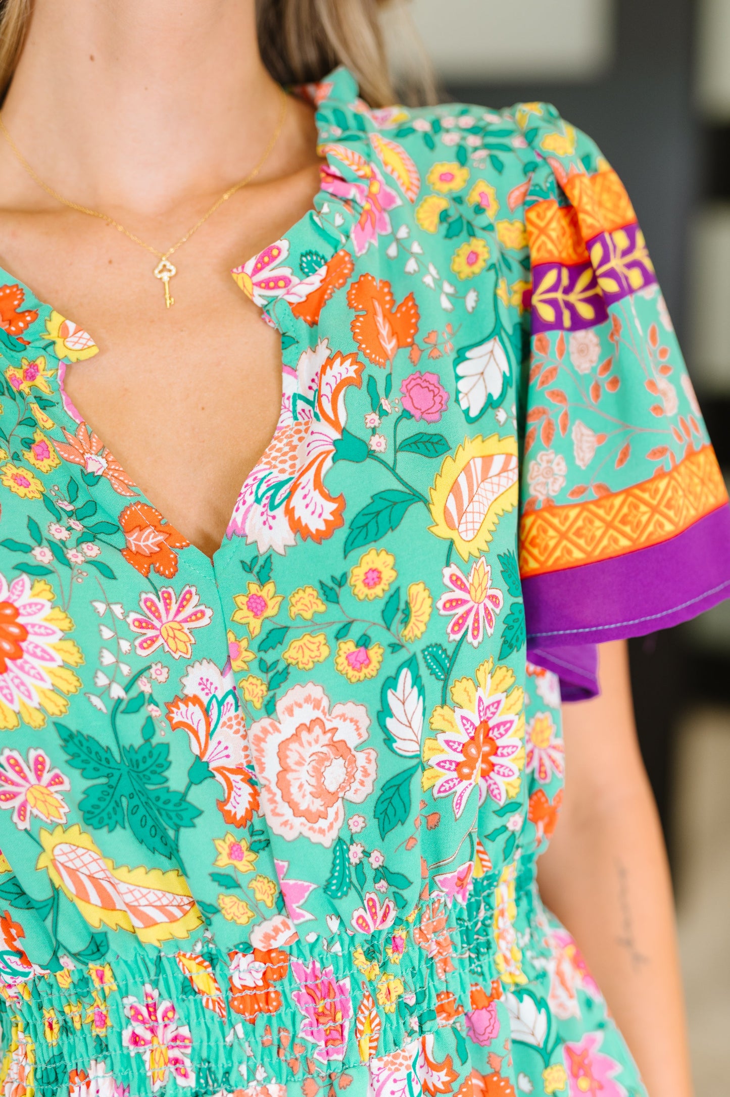 Close-up of a colorful floral dress with a blurred background