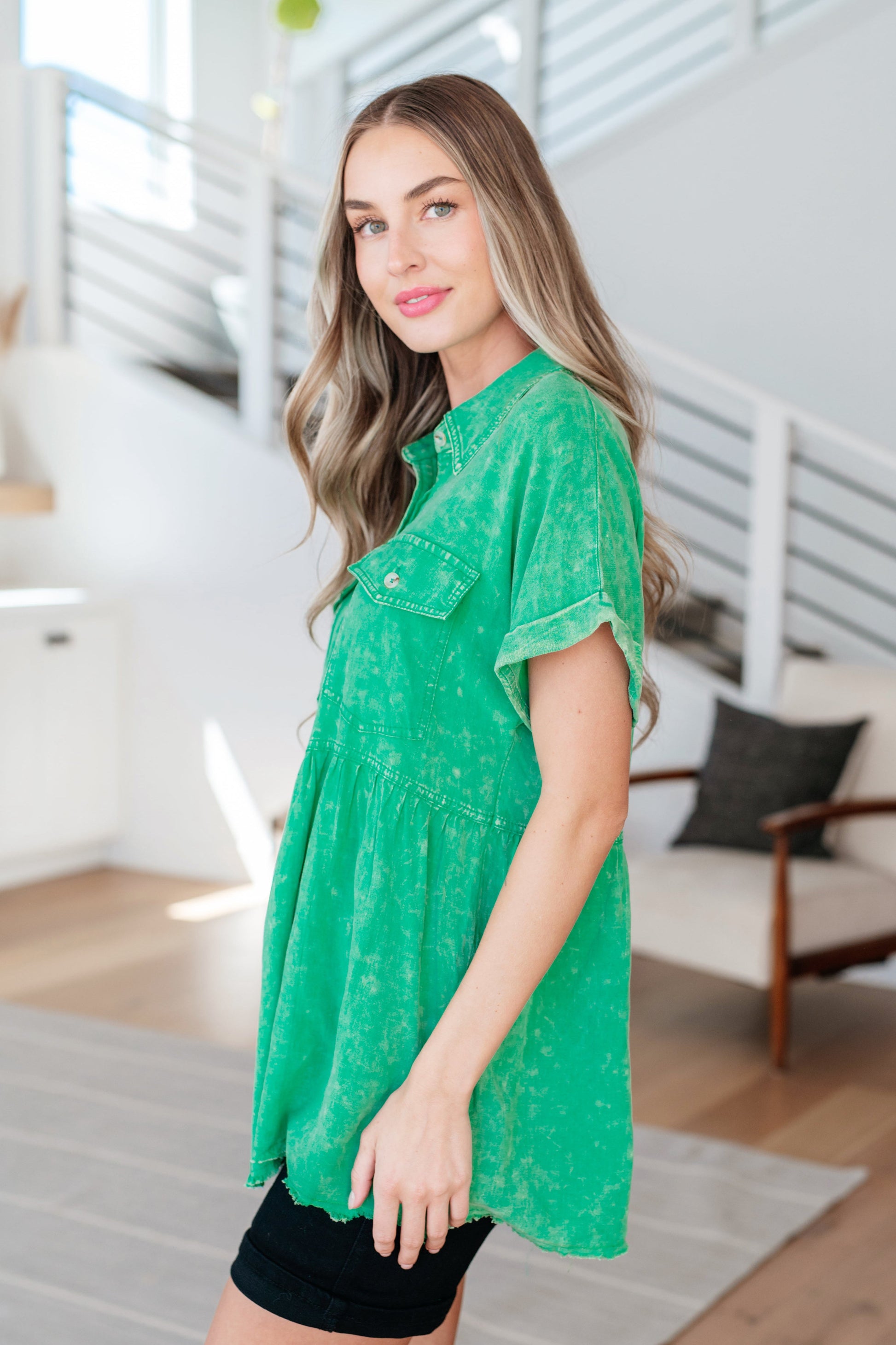 Woman wearing a green shirt in a modern living room