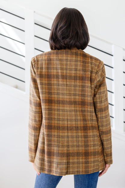 Person wearing a plaid jacket with a white background