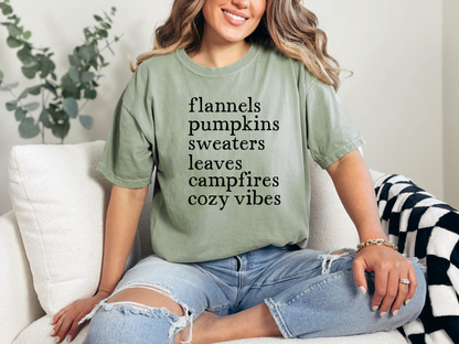 Woman wearing a green t-shirt with text, sitting on a couch.