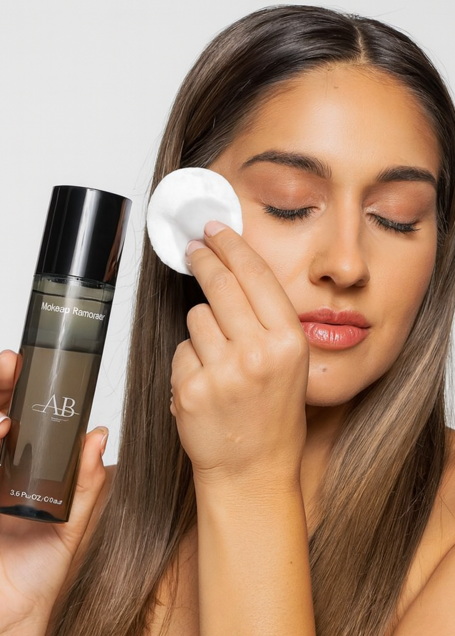 Woman applying skincare product with a cotton pad and holding a bottle labeled 'AB'.