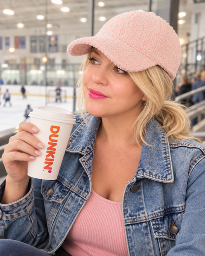 pink sherpa baseball hat sold my arnone boutique, women in a hockey rink drinking coffee