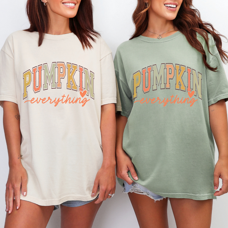 Two women wearing 'Pumpkin everything' t-shirts on a plain background
